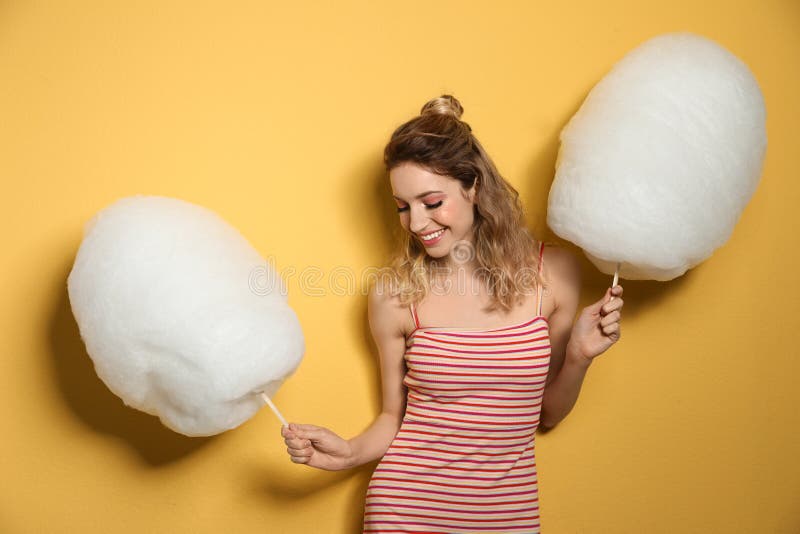 Portrait of pretty young woman with cotton candy on background royalty free stock photos Portrait of pretty young woman with cotton candy on background royalty free stock photos