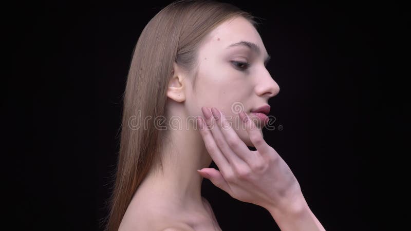 Portrait in Profile of Young and Slim Caucasian Girl with Nude Make-up Softly Touching Her Face on Black Background. Stock Video - Video of beauty, glamour: 139179421