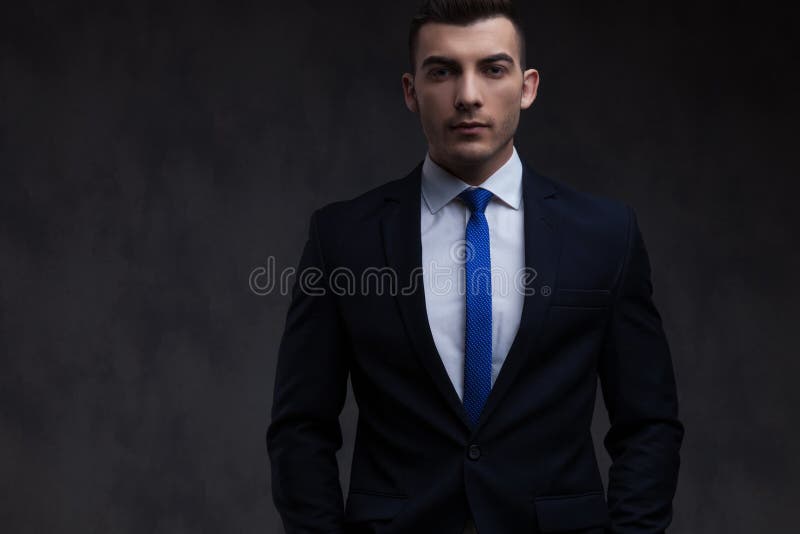 Portrait Of Relaxed Businessman Wearing Navy Suit And Blue Tie Stock Image  - Image Of Person, Smile: 135941923