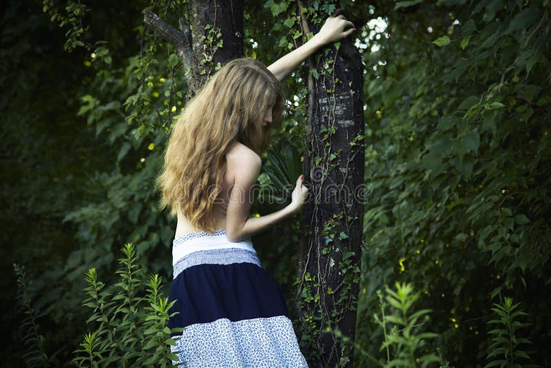 Portrait of romantic woman at the green forest