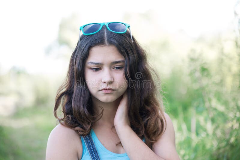 Portrait of sad teen girl on nature