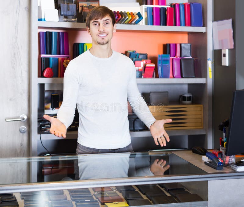 Portrait of Salesman Selling Wallets and Purses in Store Stock Image