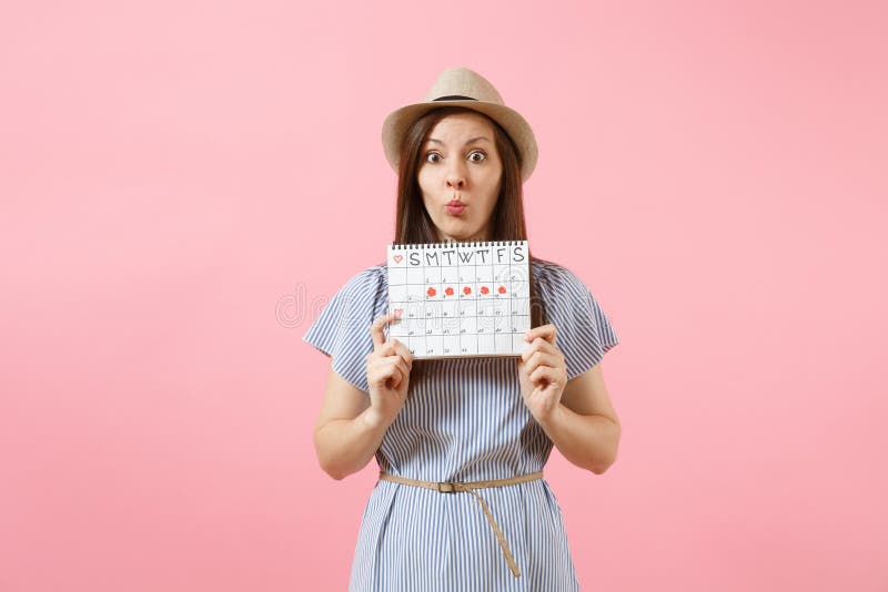 Portrait Sceptical Woman In Blue Dress Hat Holding Periods Calendar