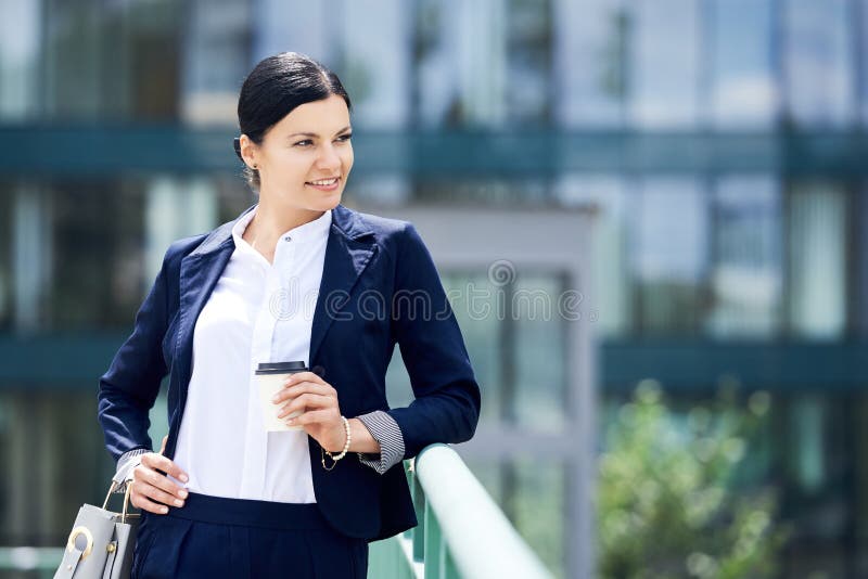 Portrait of self confidence business woman with coffee to go
