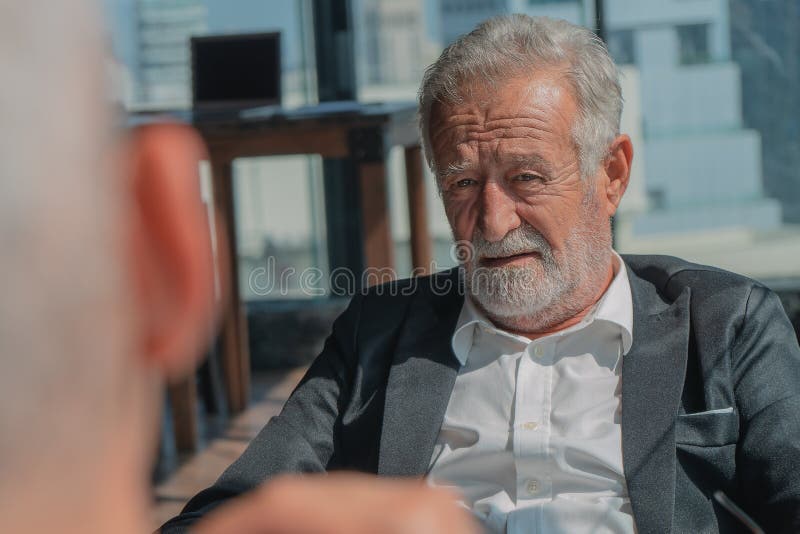 Portrait of senior businessman with beard in business suit having business talk with business colleague royalty free stock images Portrait of senior businessman with beard in business suit having business talk with business colleague royalty free stock images