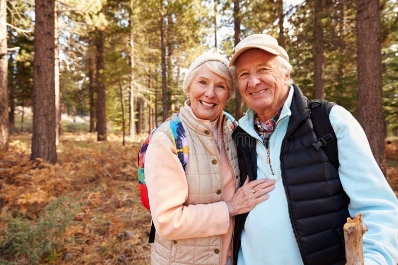 Portrait of senior couple hiking in forest, California, USA.