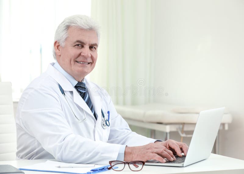 Portrait of Senior Doctor in Coat at Workplace Stock Photo - Image of ...