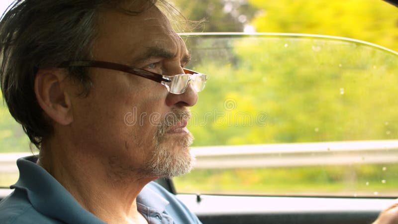 Portrait of senior man driving a car