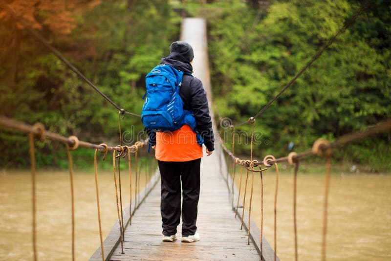 Portrait Of Senior Woman with backpack On Hike cross river royalty free stock photography Portrait Of Senior Woman with backpack On Hike cross river royalty free stock photography