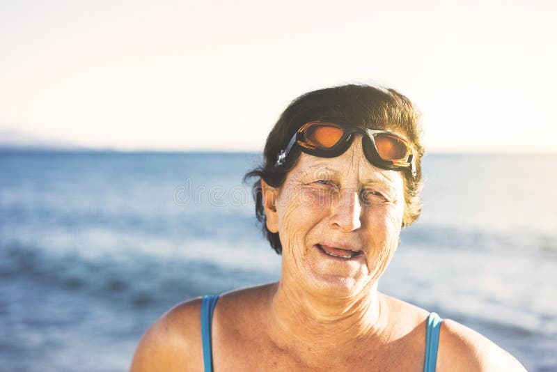 Portrait of a Senior Woman Wearing a Blue Swimsuit and Swimming Goggles ...