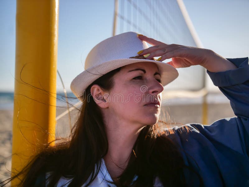 Portrait of a serious attractive brunette girl in a white hat, looks away stock image Portrait of a serious attractive brunette girl in a white hat, looks away stock image