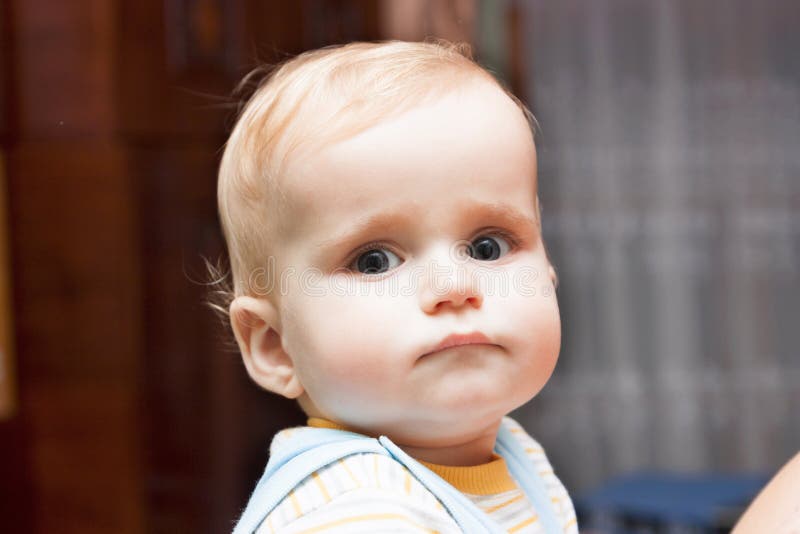 Portrait of upset baby stock photo. Image of human, green 83077894