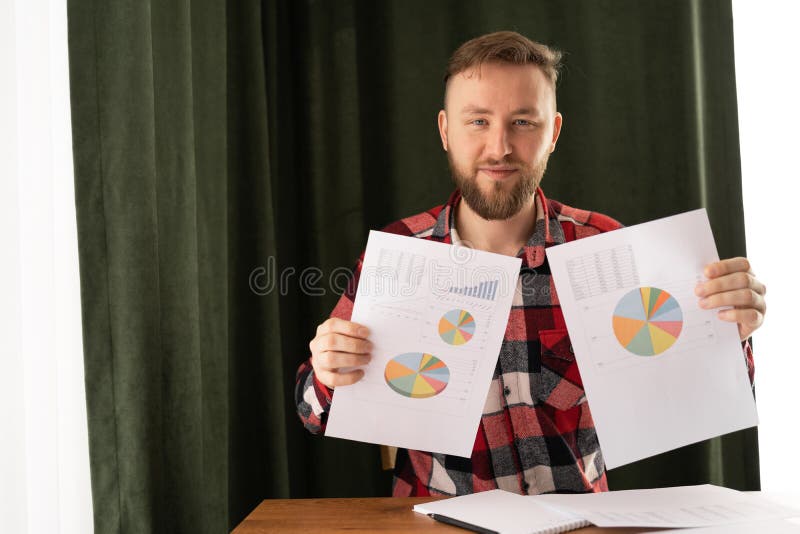 Portrait of serious businessman learning financial data and documents with chart and graph in office. Business royalty free stock photo