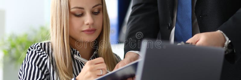 Portrait of serious businesswoman working in office. Man holding paper folder with contract and partner underwriting agreement. Biz concept. Blurred background. Portrait of serious businesswoman working in office. Man holding paper folder with contract and partner underwriting agreement. Biz concept. Blurred background