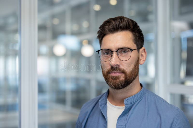 Portrait of a serious confident businessman, a man looks thoughtfully into the camera. A company developer employee royalty free stock photos