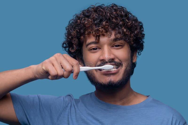 Cute Indian Guy Performing a Tooth-brushing Procedure Stock Photo ...