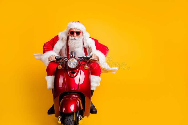Portrait of serious hipster santa claus in red hat drive his scooter hurry rider ride to x-mas christmas party wear stock image Portrait of serious hipster santa claus in red hat drive his scooter hurry rider ride to x-mas christmas party wear stock image