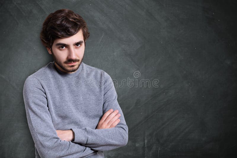 A portrait of serious young bearded guy with stylish hairstyle d royalty free stock photography A portrait of serious young bearded guy with stylish hairstyle d royalty free stock photography