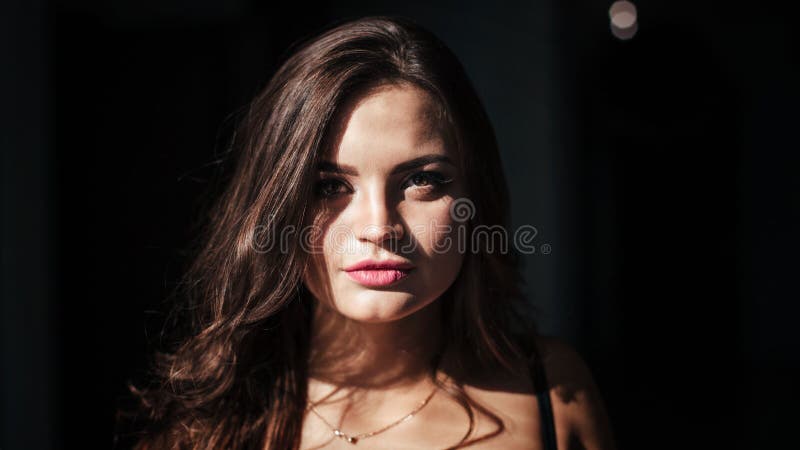 Portrait Of A Brunette In A Black Dress On A Dark Background Girl