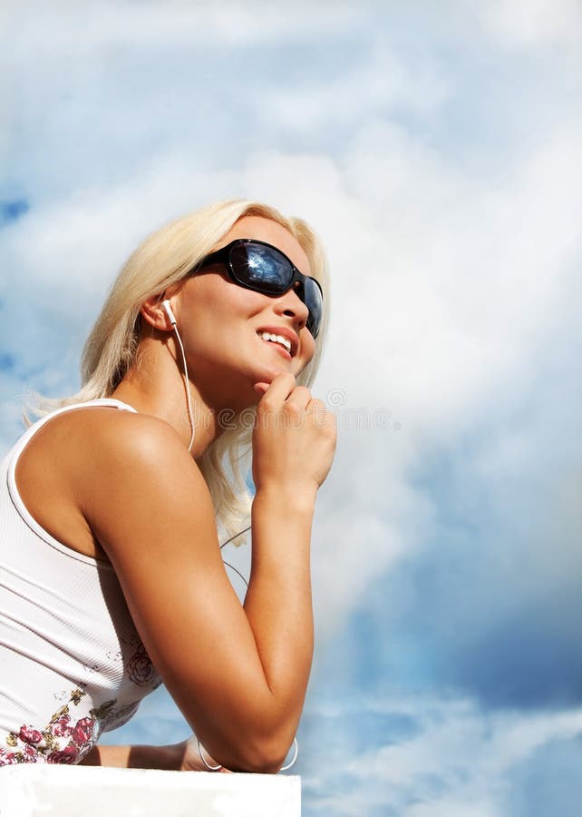 Portrait of young woman listening music