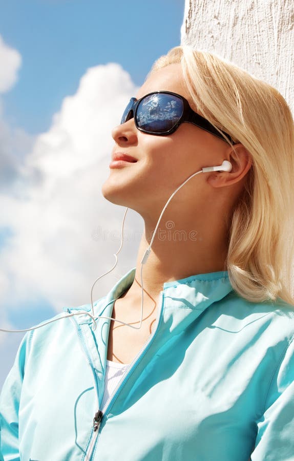 Portrait of young woman listening music