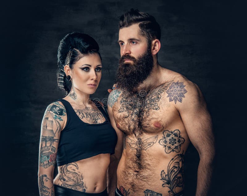 Premium Photo | A professional female tattoo artist makes black and white  tattoo on bearded male torso in a salon.