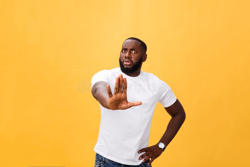 Portrait shock and annoyed displeased young man raising hands up to say no stop right there isolated orange background