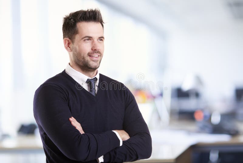 Businessman standing with folded arms in the office royalty free stock images Businessman standing with folded arms in the office royalty free stock images