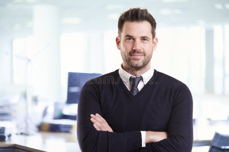 Casual businessman portrait while standing in the office with folded arms stock photos Casual businessman portrait while standing in the office with folded arms stock photos
