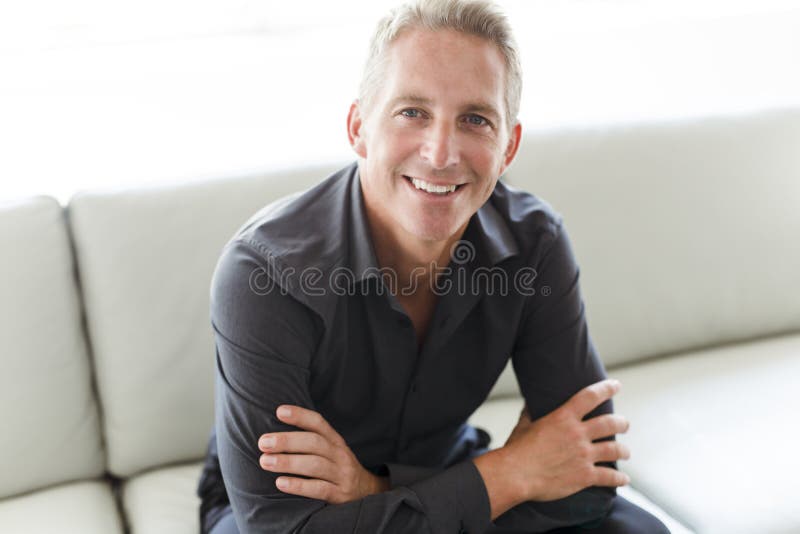 Portrait of single 40s man sitting in sofa