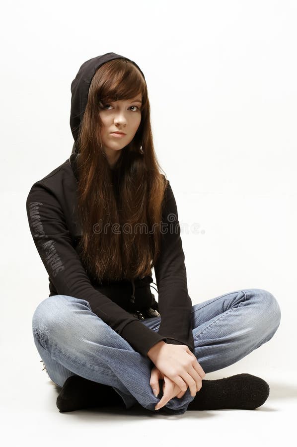 Portrait of the sitting girl in jeans