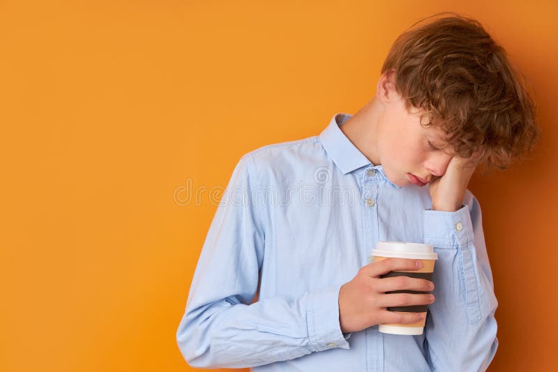 Portrait Of Sleepy Teenager Boy With Cup Of Coffee Stock Photo Image