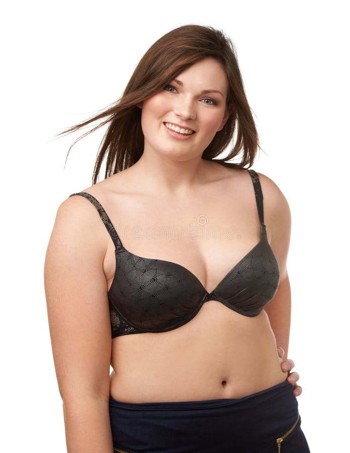 Fotografia do Stock: Young beautiful busty curvy plus size model with big  breast in white bra, xxl woman. Black background.