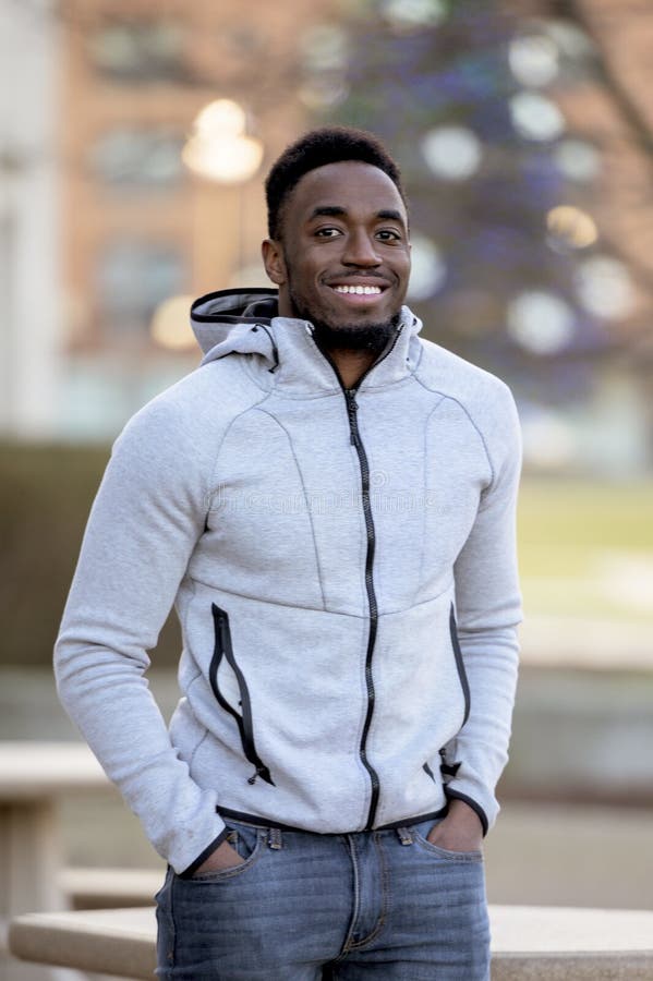 Portrait of a Smiling African-American Man in a Park Under Sunlight ...