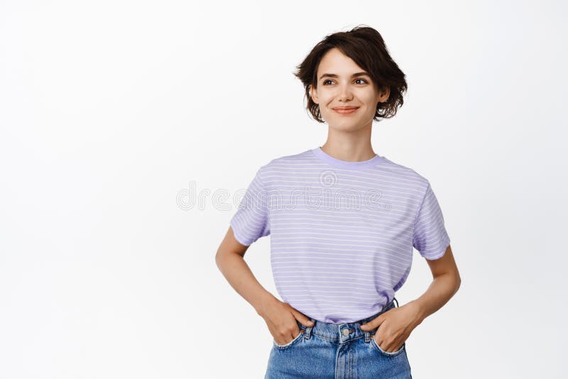 Portrait of smiling beautiful girl, young woman with short hairstyle in  jeans and t-shirt, looking aside at banner sale with pleased face, white  Stock Photo - Alamy