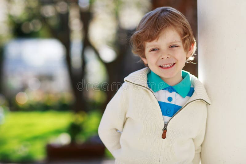 Portrait of smiling blond preschool boy, outdoors stock photography Portrait of smiling blond preschool boy, outdoors stock photography
