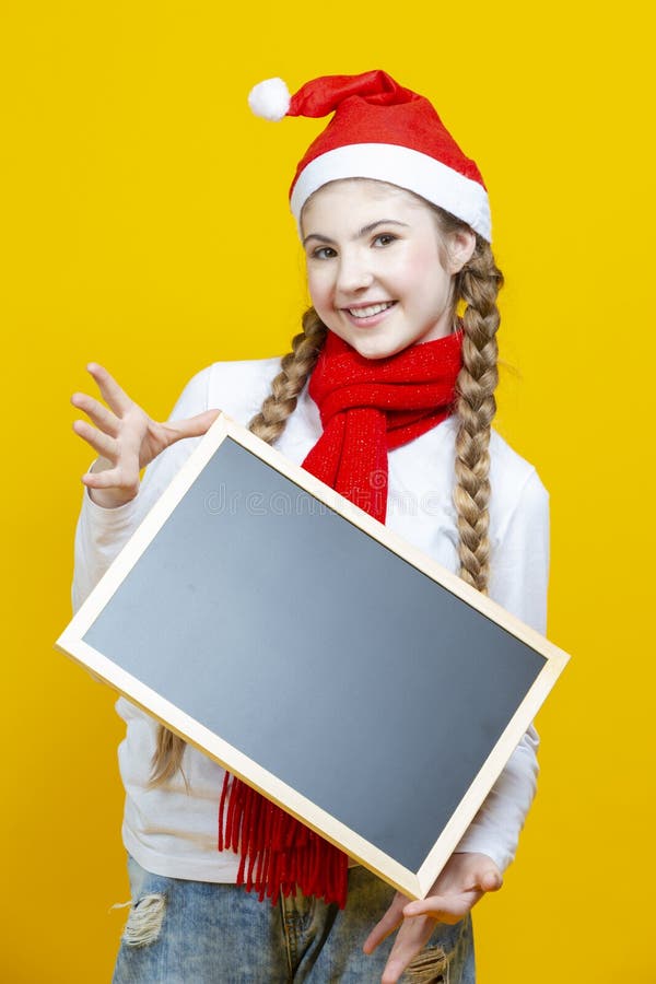 Portrait of Smiling Caucasian Girl in Santa Hat Holding Empty Black Magnet Letter Board