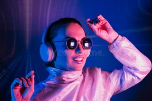 Portrait Of A Smiling Dancing Woman In Sunglasses And Headphones In Portrait Of A Smiling Dancing Woman In Sunglasses And Headphones In