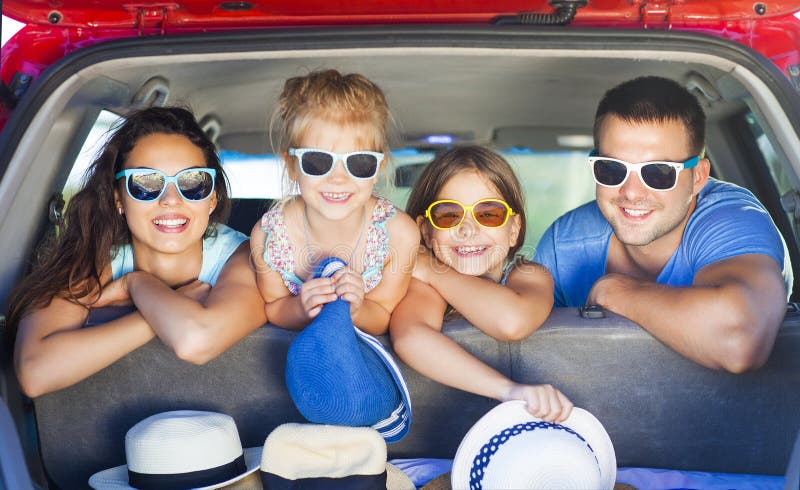 Portrait of a smiling family with two children at beach in the c