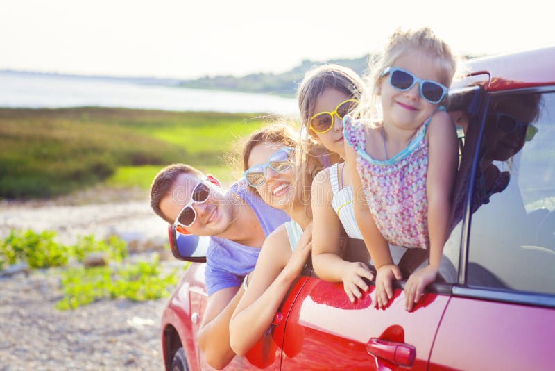 Portrait of a smiling family with two children at beach in the c