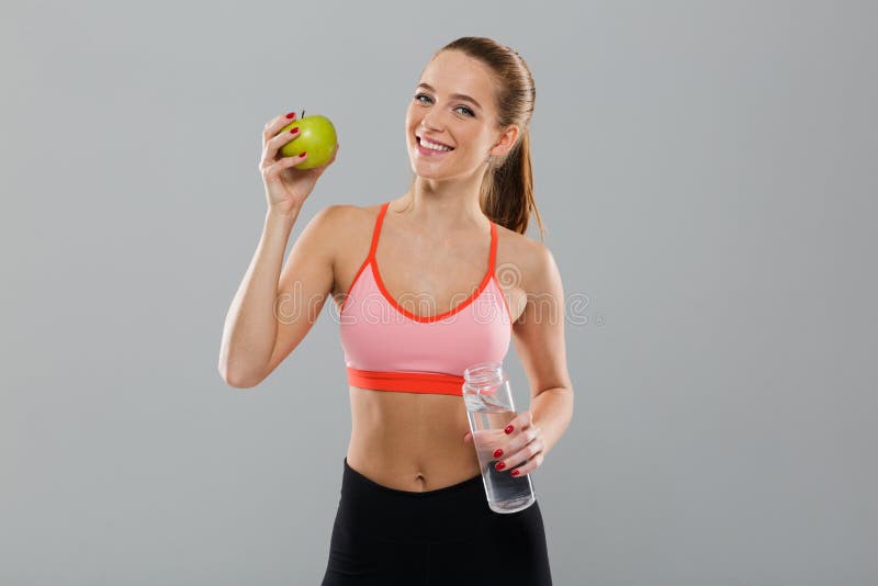 Portrait of smiling healthy sports girl holding green apple royalty free stock photo Portrait of smiling healthy sports girl holding green apple royalty free stock photo
