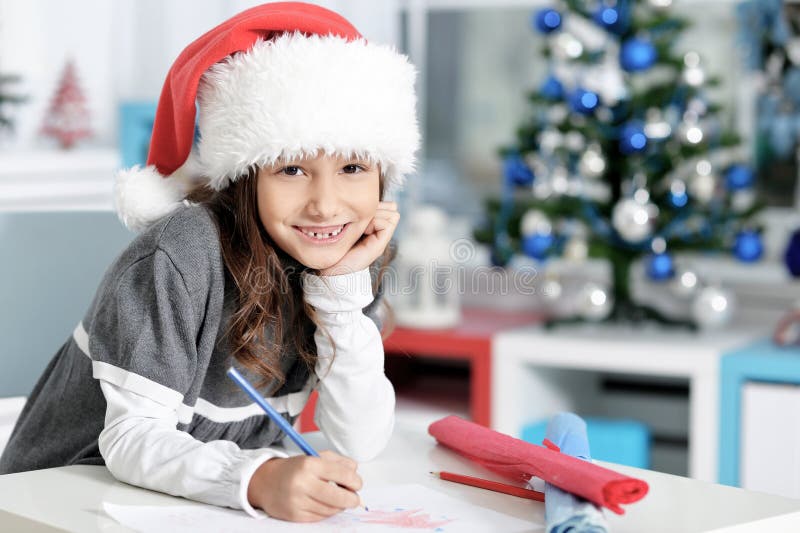 Portrait of smiling little girl writing letter. Close up portrait of smiling little girl writing letter stock photos Portrait of smiling little girl writing letter. Close up portrait of smiling little girl writing letter stock photos