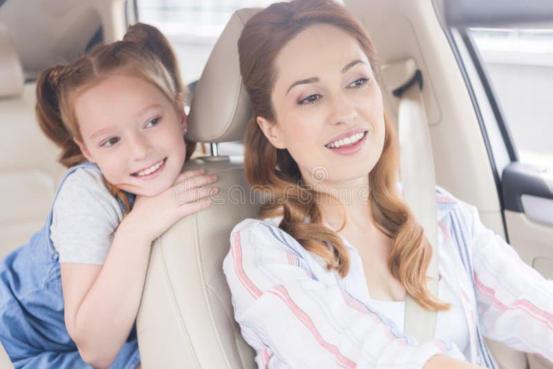 Portrait Of Smiling Mother Driving Car With Daughter Stock Image