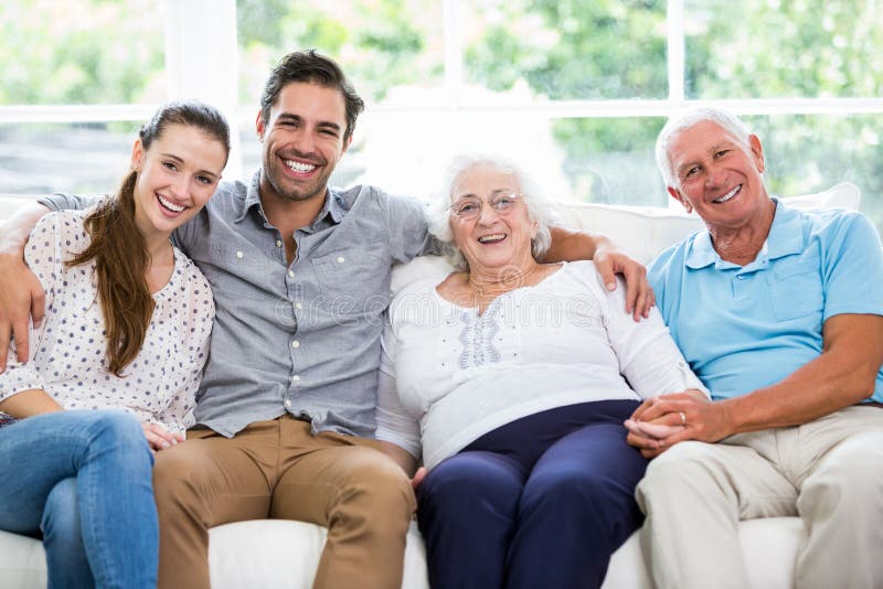 Portrait of smiling multi-generation family sitting on sofa royalty free stock images Portrait of smiling multi-generation family sitting on sofa royalty free stock images