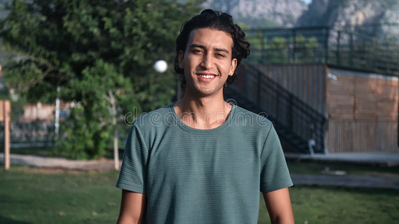 Portrait smiling Spanish curly guy posing at summer mountain city park landscape positive emotion stock video