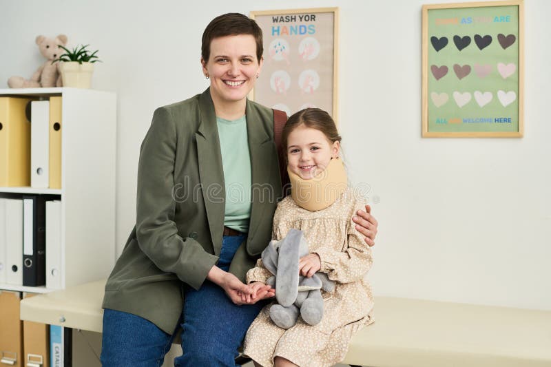Portrait of Smiling Woman Sitting Beside Girl Holding Toy royalty free stock photos