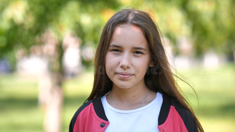 Portrait of a smiling 11 year old girl with long hair.