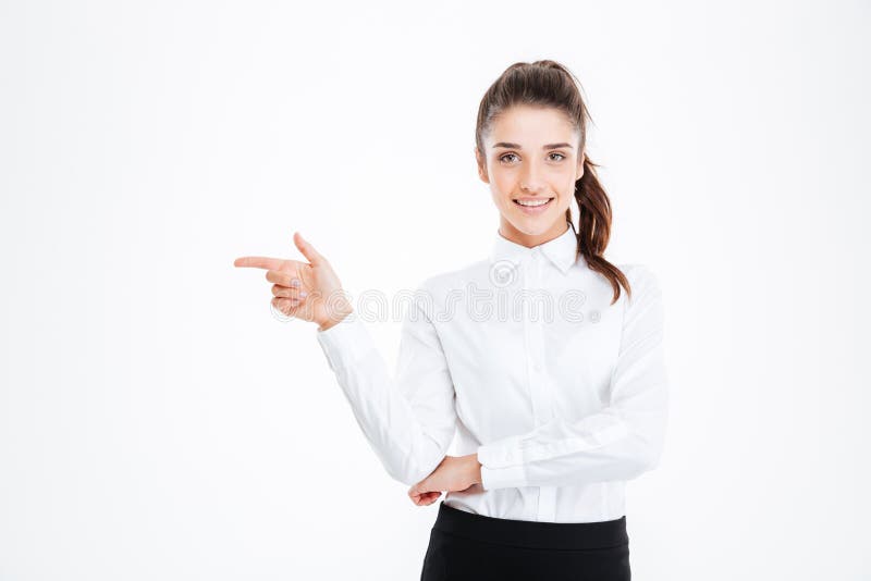 Portrait of a smiling young businesswoman pointing finger away