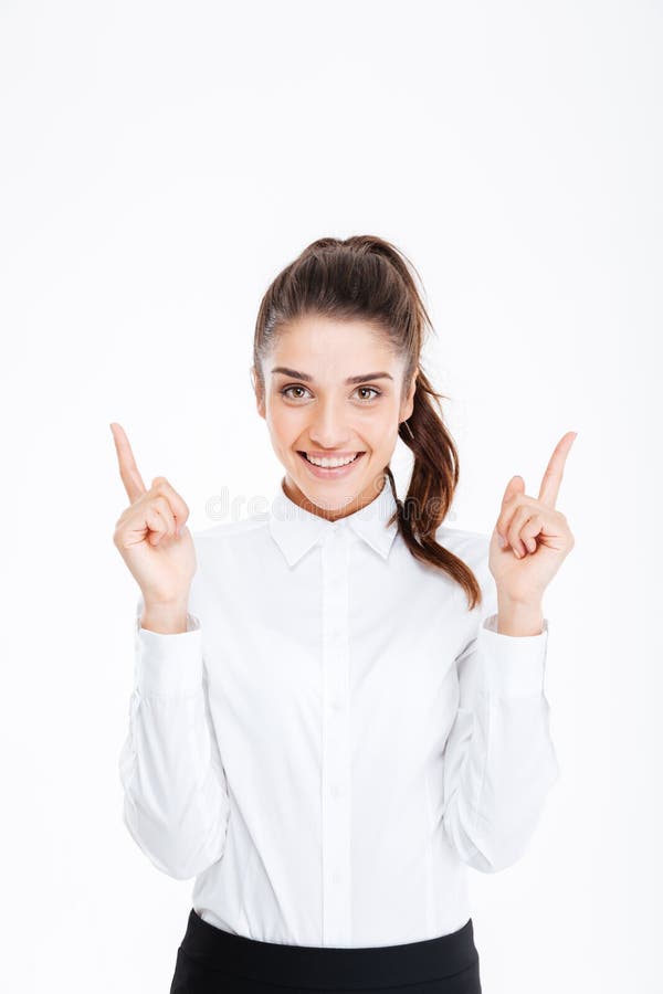 Portrait Of A Smiling Young Businesswoman Pointing Fingers Up Stock