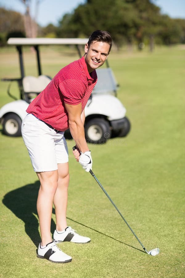 Portrait of smiling young man playing golf